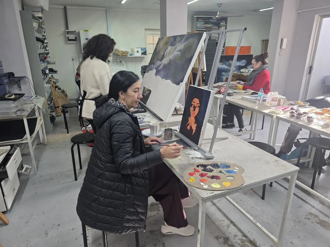 Student painting a portrait